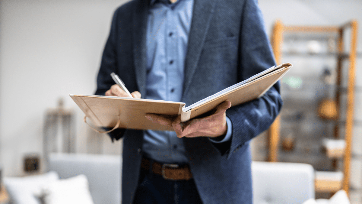 appraisal, man writing down something on a big notebook